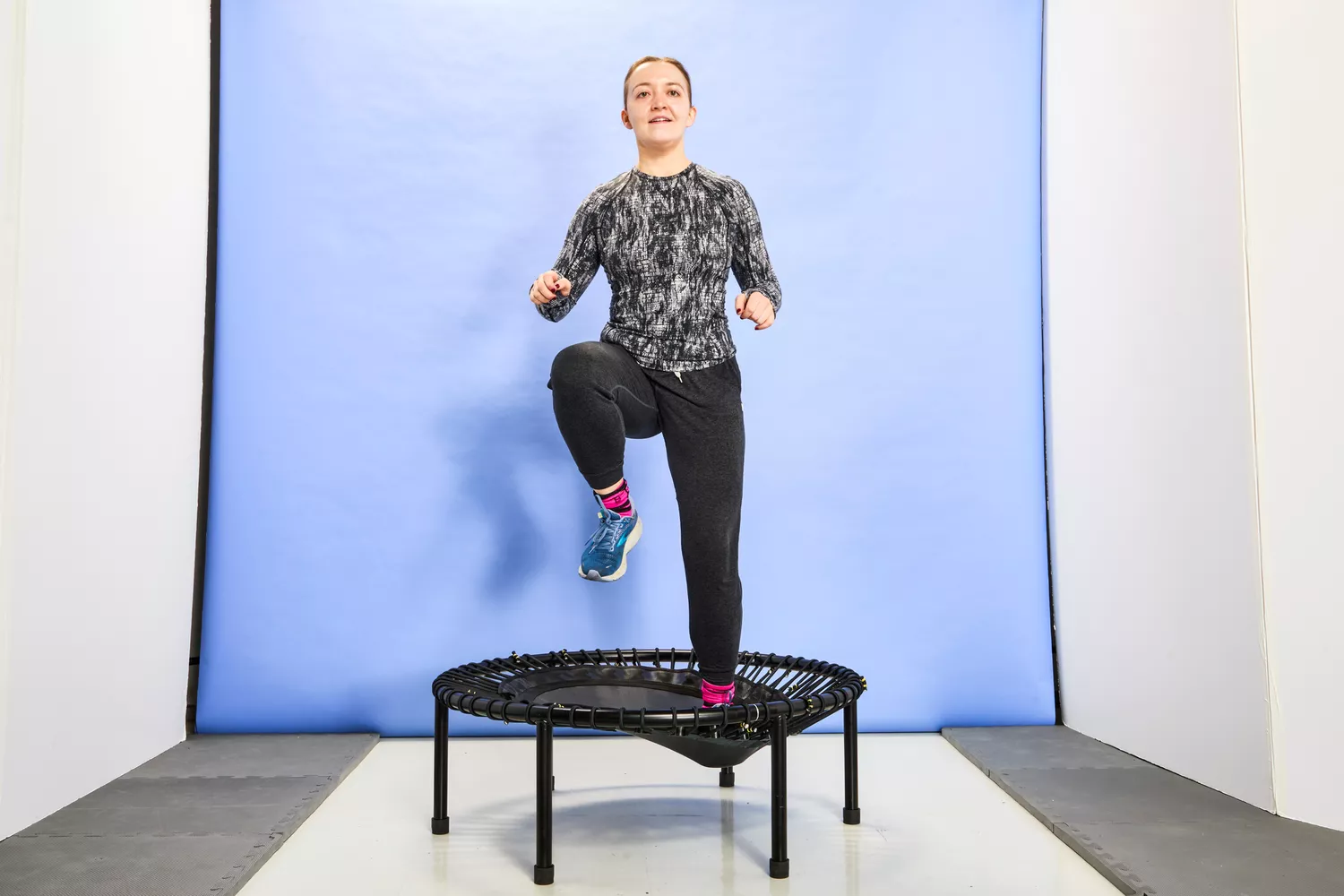 A person preparing to jump with one knee up on the bellicon 39 Inch Mini Trampoline