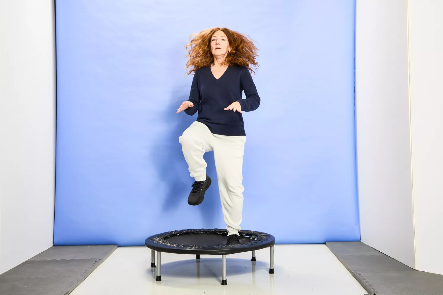 A person jumping with one knee up on the Fitness Gear Mini Trampoline