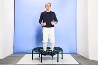 A person jumping on the Leaps and Rebounds Mini Fitness Trampoline and Rebounder