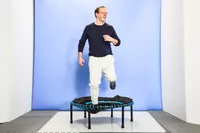 A person using the Leaps and Rebounds Mini Fitness Trampoline and Rebounder with one leg