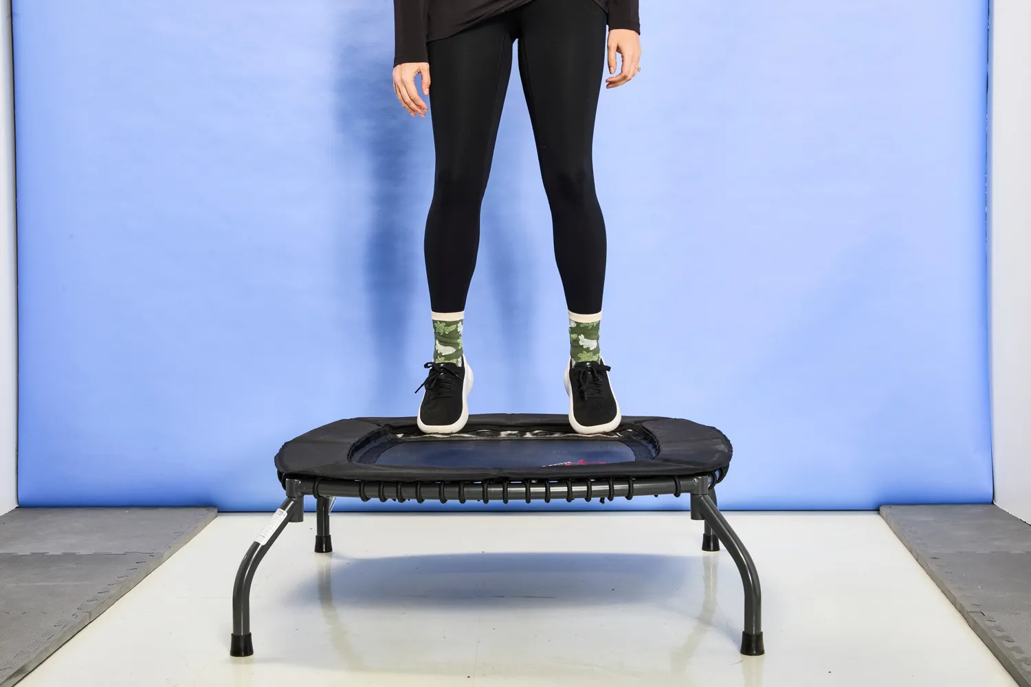 A person hovering slightly over the Sunny Health & Fitness 36 Inch Indoor & Outdoor Exercise Trampoline