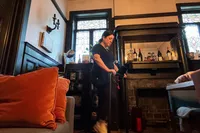 A person folds up the Urevo Strol 2E Under Desk Treadmill