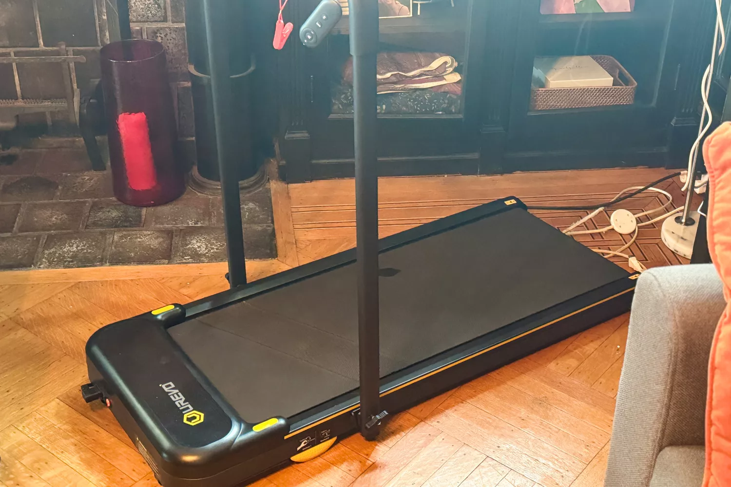 The Urevo Strol 2E Under Desk Treadmill in a living room