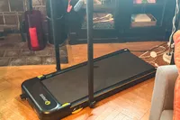 The Urevo Strol 2E Under Desk Treadmill in a living room