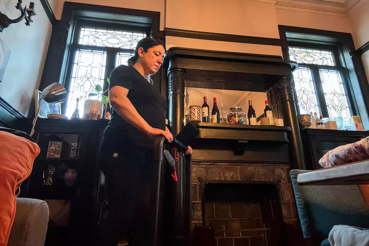 A person folds up the Urevo Strol 2E Under Desk Treadmill