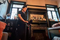 A person folds up the Urevo Strol 2E Under Desk Treadmill