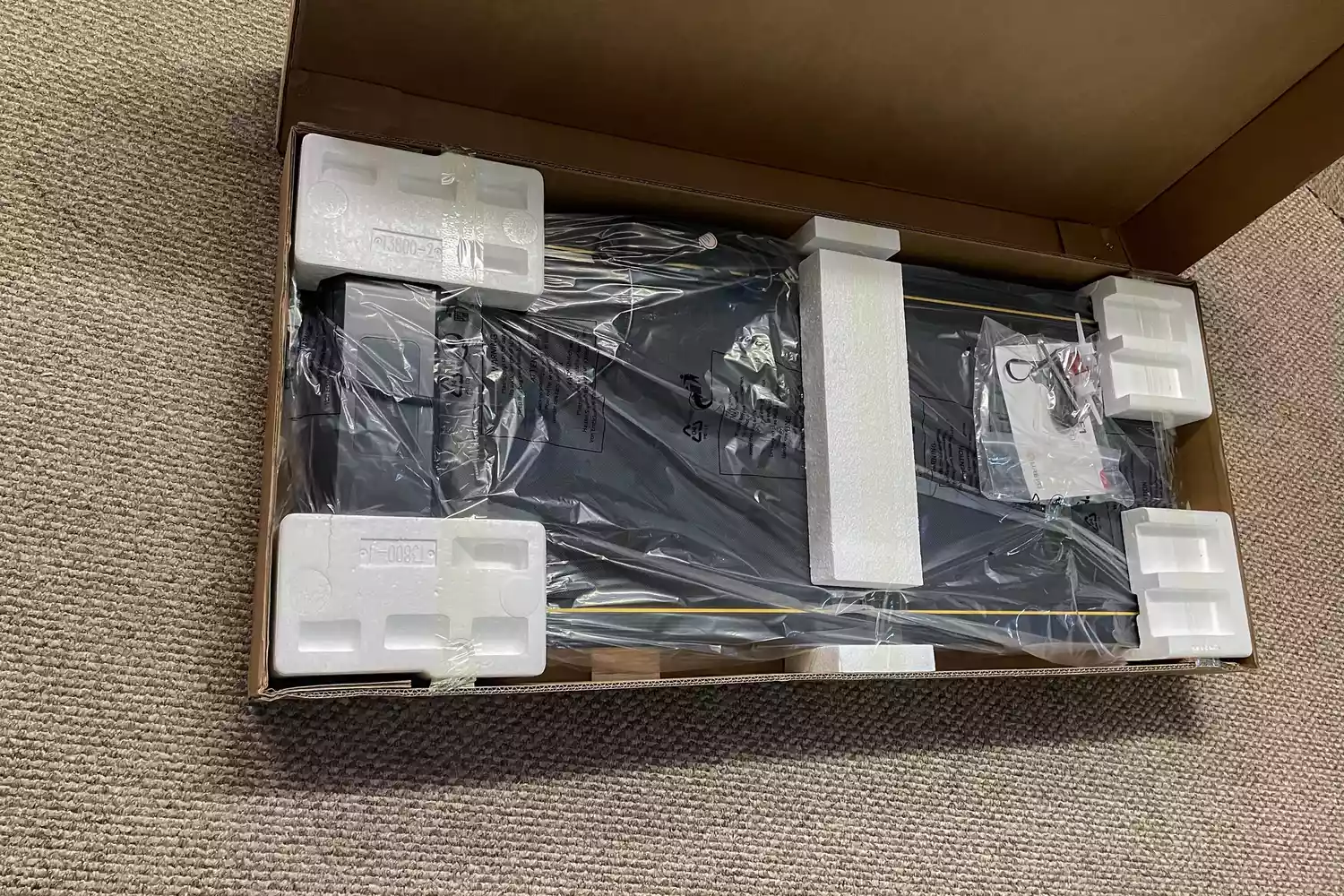 The UREVO Walking Pad Under Desk Treadmill in its original packaging