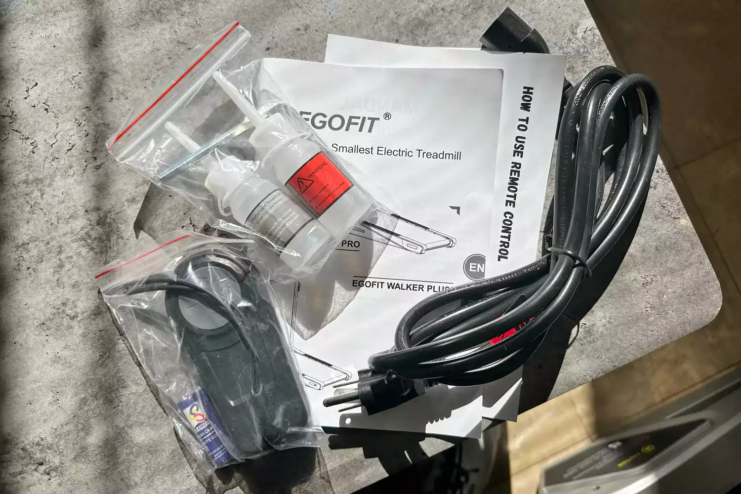 Egofit Walker Pro-M1 Treadmill cord, manual, and accessories