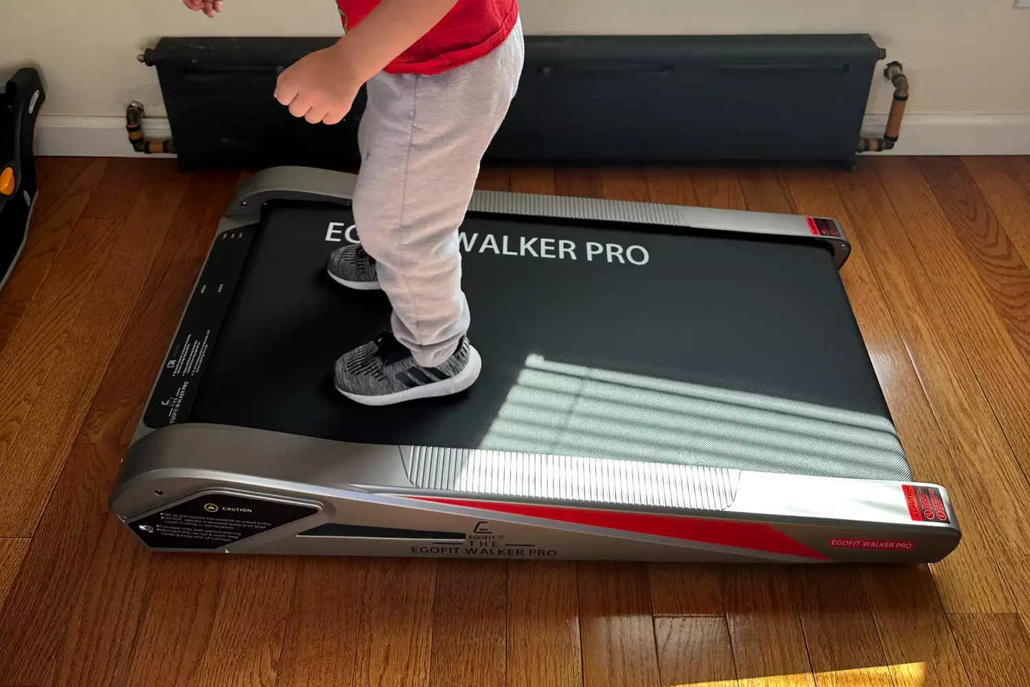 Child standing on Egofit Walker Pro-M1 Treadmill