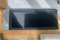 WalkingPad P1 Foldable Walking Treadmill on wood floor alongside rug