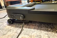 The remote control for the Urevo SpaceWalk 3S Treadmill attached to the base