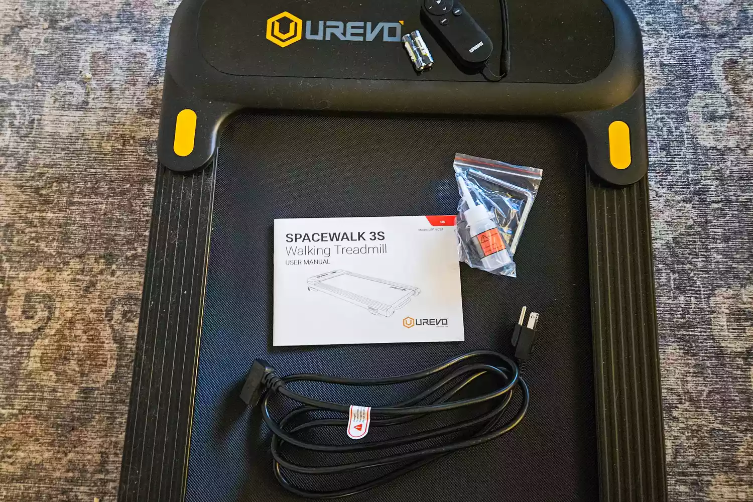 The Urevo SpaceWalk 3S Treadmill with user manual and accessories