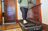 A person walks on the Urevo SpaceWalk 3S Treadmill