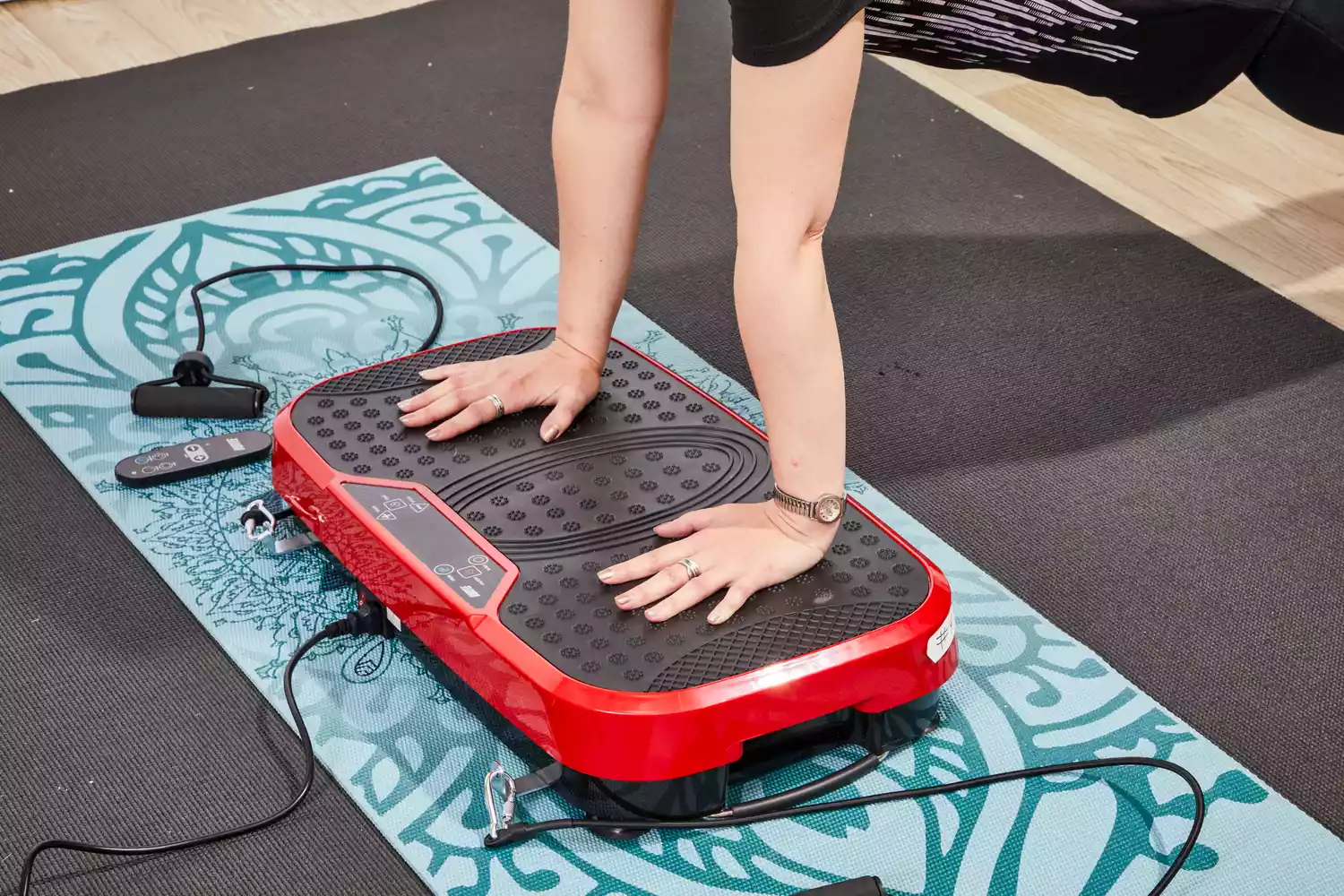 A person does a pushup on the Hurtle Fitness Vibration Platform Machine