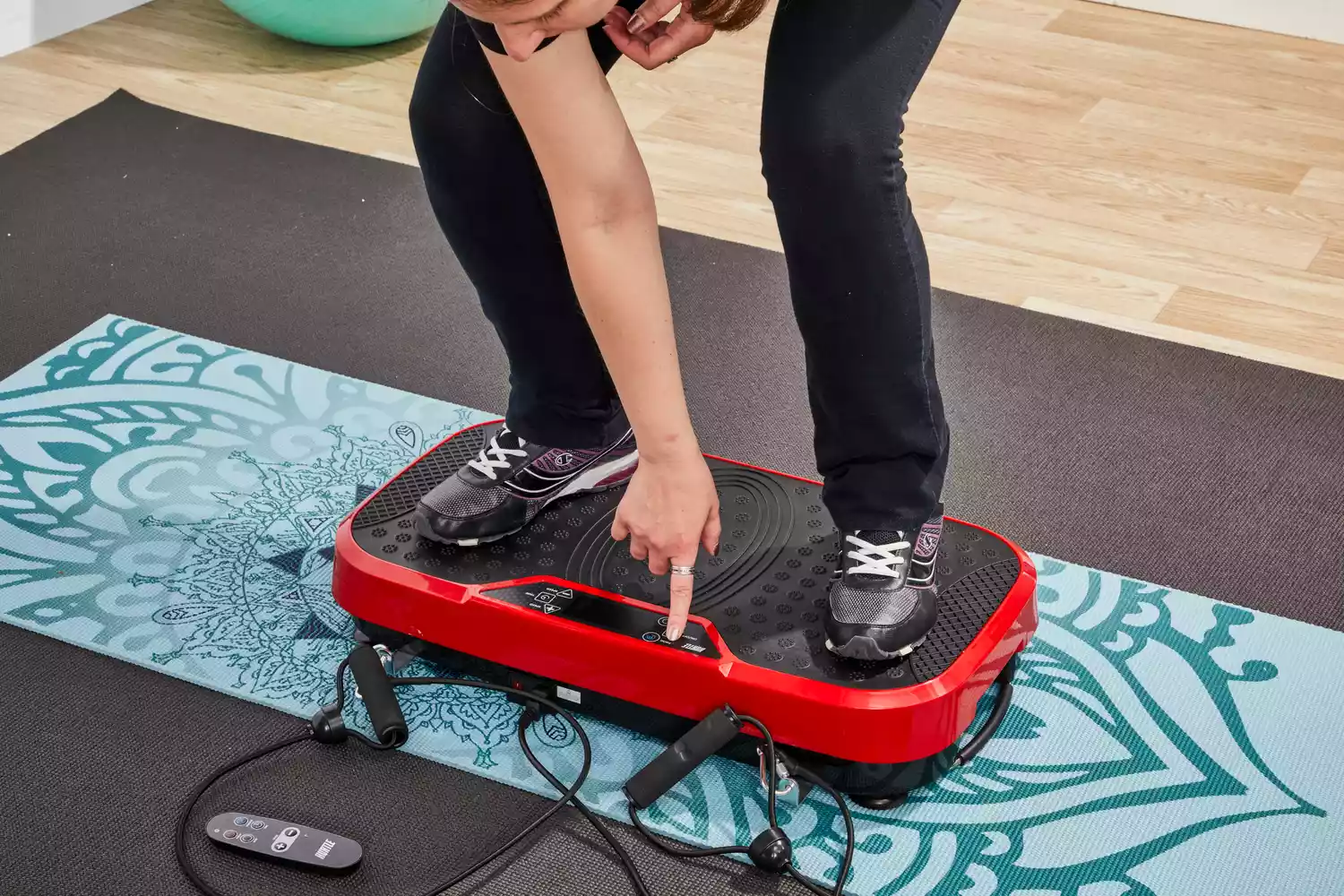 A person presses a button on the Hurtle Fitness Vibration Platform Machine