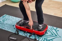 A person presses a button on the Hurtle Fitness Vibration Platform Machine