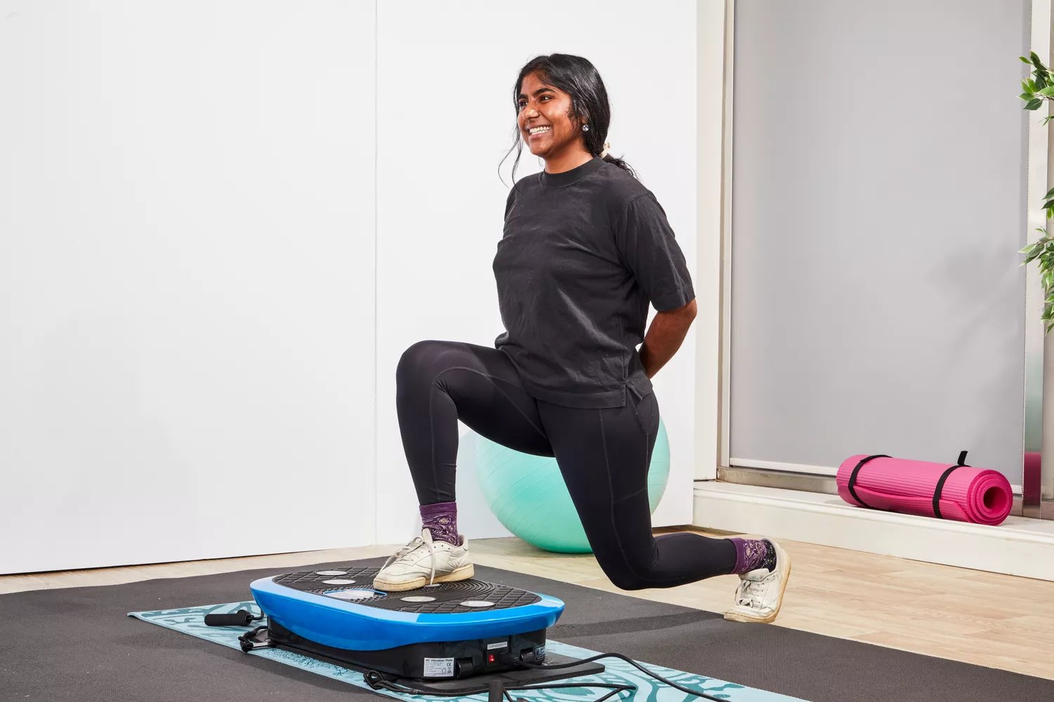 A person does lunges on the LifePro Rumblex Plus 4D Vibration Plate Exercise Machine