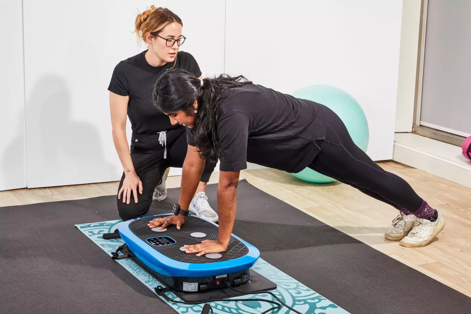 A person does a pushup on the LifePro Rumblex Plus 4D Vibration Plate Exercise Machine