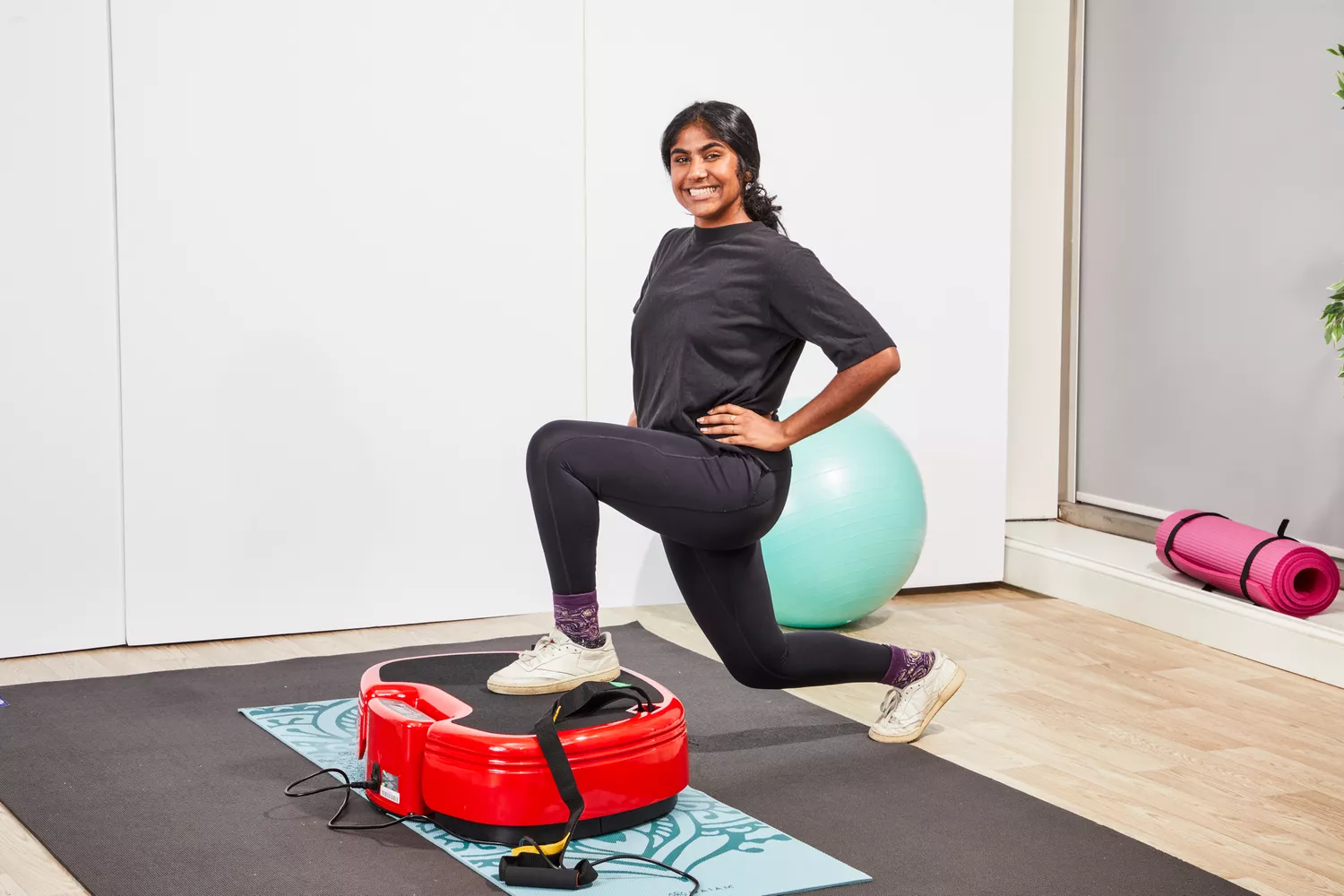 A person lunges on the Power Plate MOVE Vibrating Plate