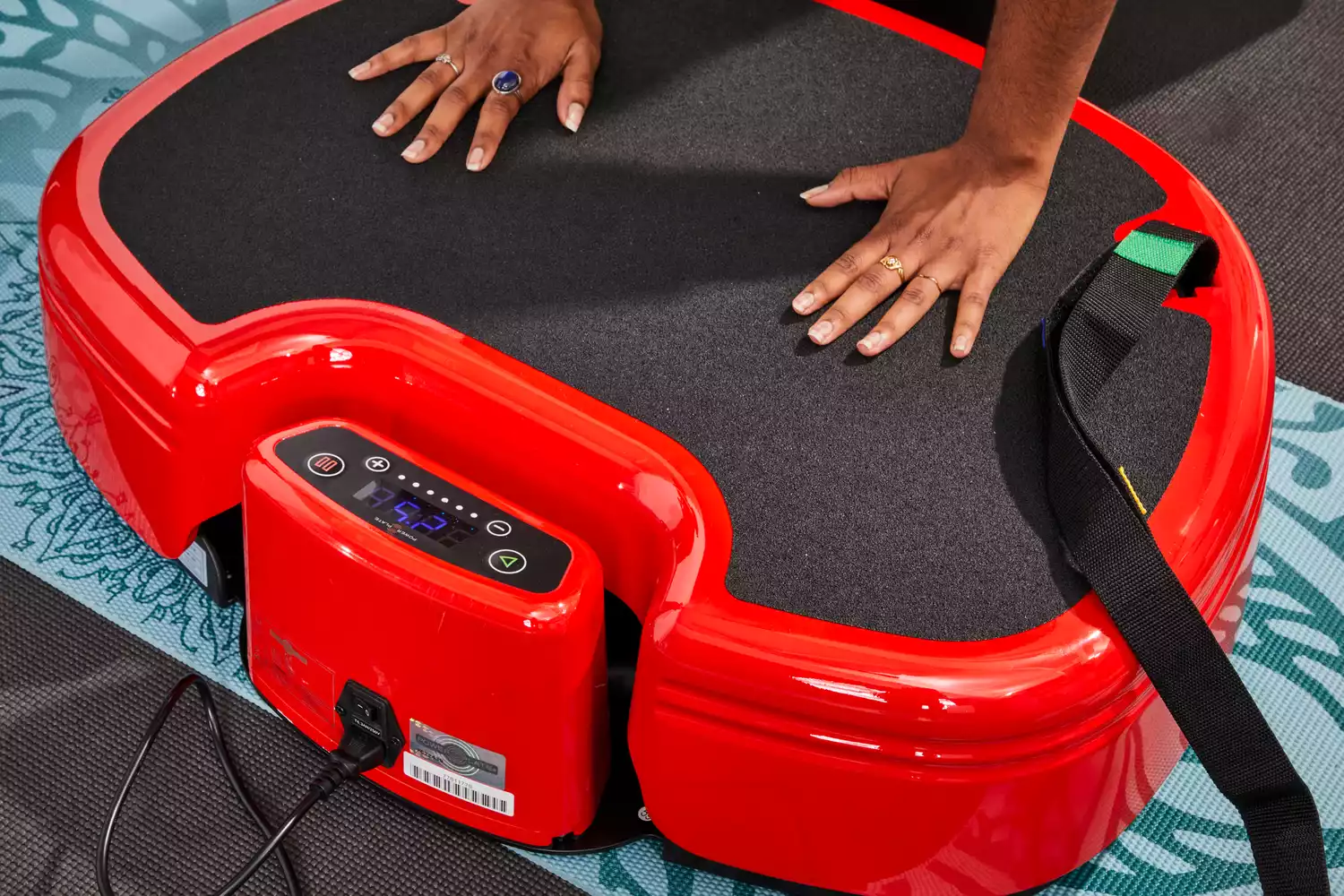 A person does pushups on the Power Plate MOVE Vibrating Plate