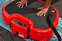 A person does pushups on the Power Plate MOVE Vibrating Plate