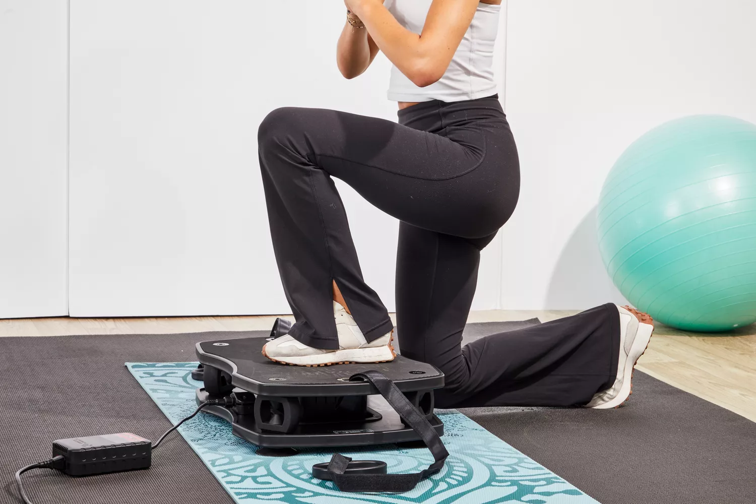 A person lunges on the VT Vibration Therapeutic Frequency Vibration Plate