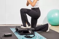A person lunges on the VT Vibration Therapeutic Frequency Vibration Plate