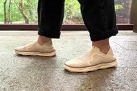 A person walks on a stone floor while wearing the Vionic Women's Sage RX Recovery Slip-On Shoes