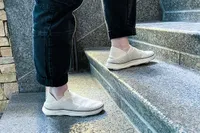 A person walks up the stairs while wearing the Vionic Women's Sage RX Recovery Slip-On Shoes