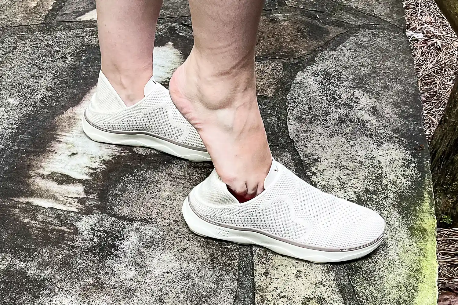 A person places their foot into the Vionic Women's Sage RX Recovery Slip-On Shoes