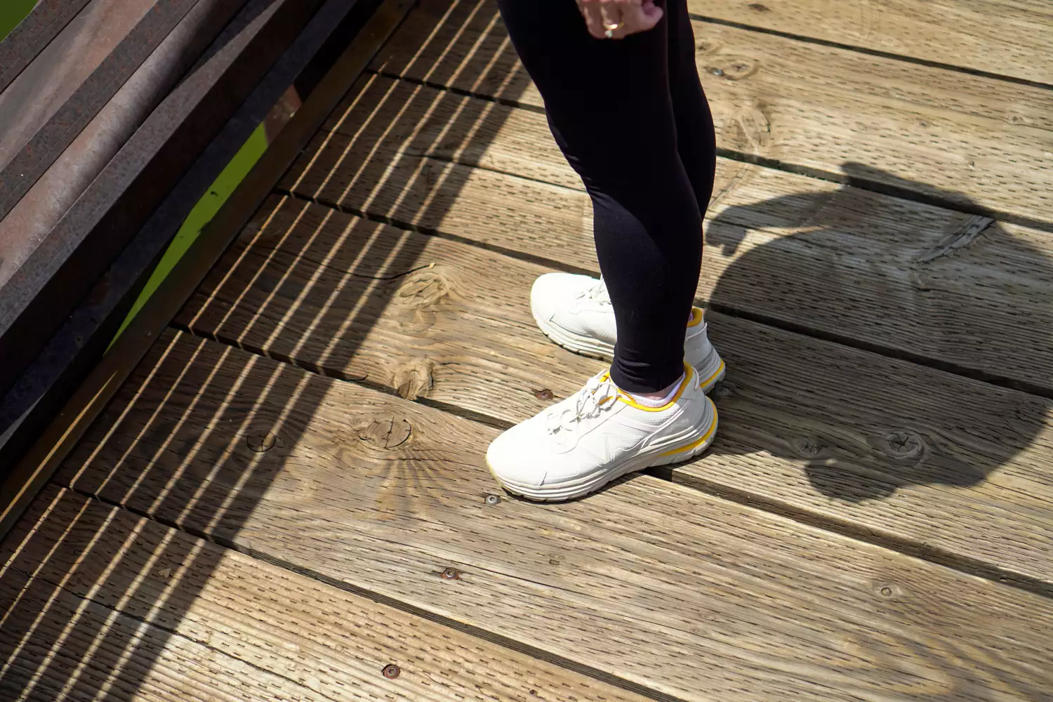 A person stands outside while wearing the Vionic Walk Max Sierra Sneaker