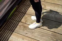 A person stands outside while wearing the Vionic Walk Max Sierra Sneaker