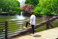 A person stretches while wearing the Vionic Walk Max Sierra Sneaker