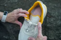 A person holds the Vionic Walk Max Sierra Sneaker open