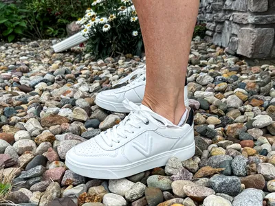 A side view of a person wearing the Vionic Women's Kimmie Court Sneakers
