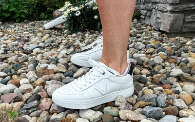 A side view of a person wearing the Vionic Women's Kimmie Court Sneakers