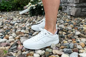 A side view of a person wearing the Vionic Women's Kimmie Court Sneakers