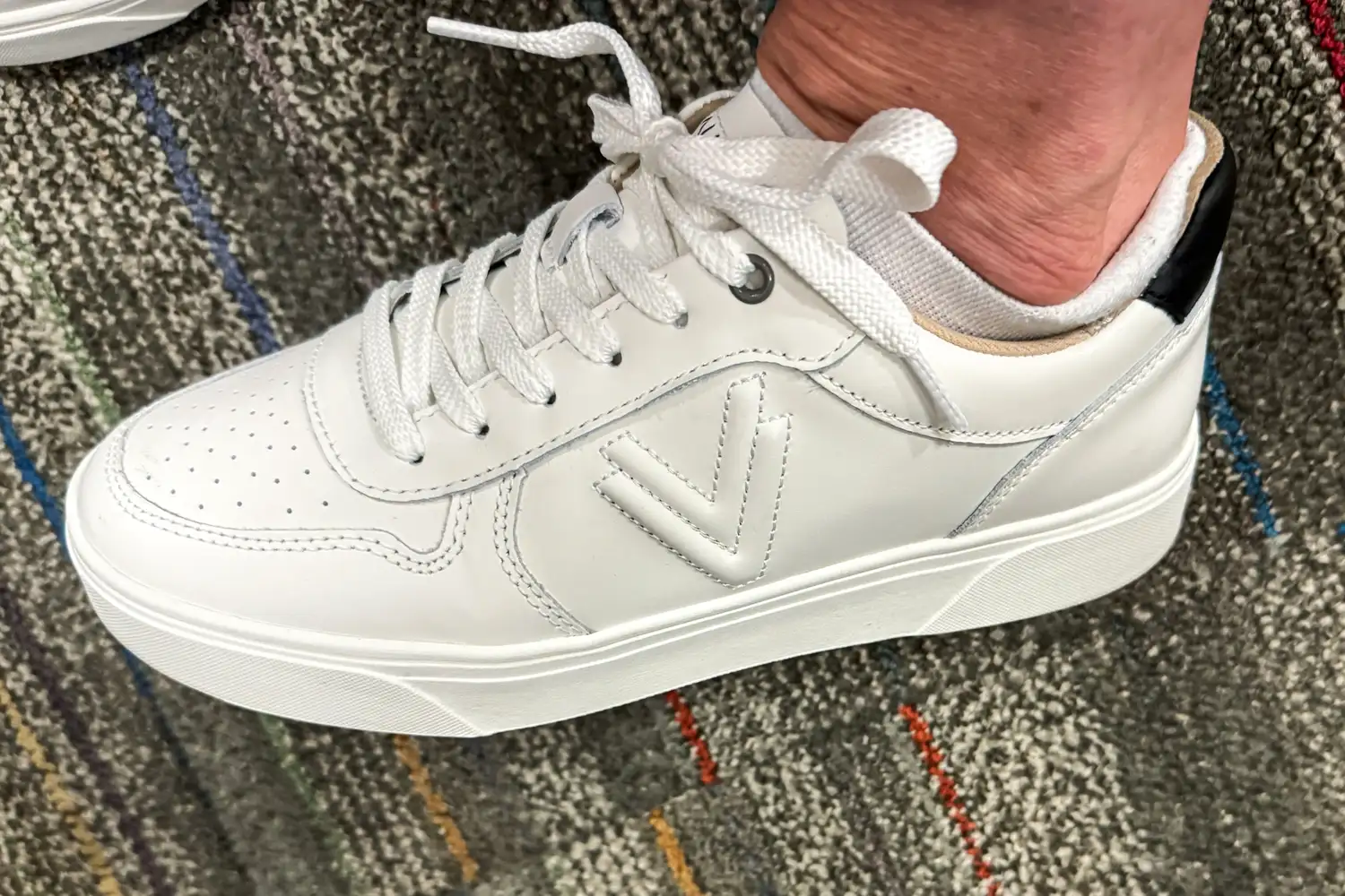 A side view of a person wearing the Vionic Women's Kimmie Court Sneakers