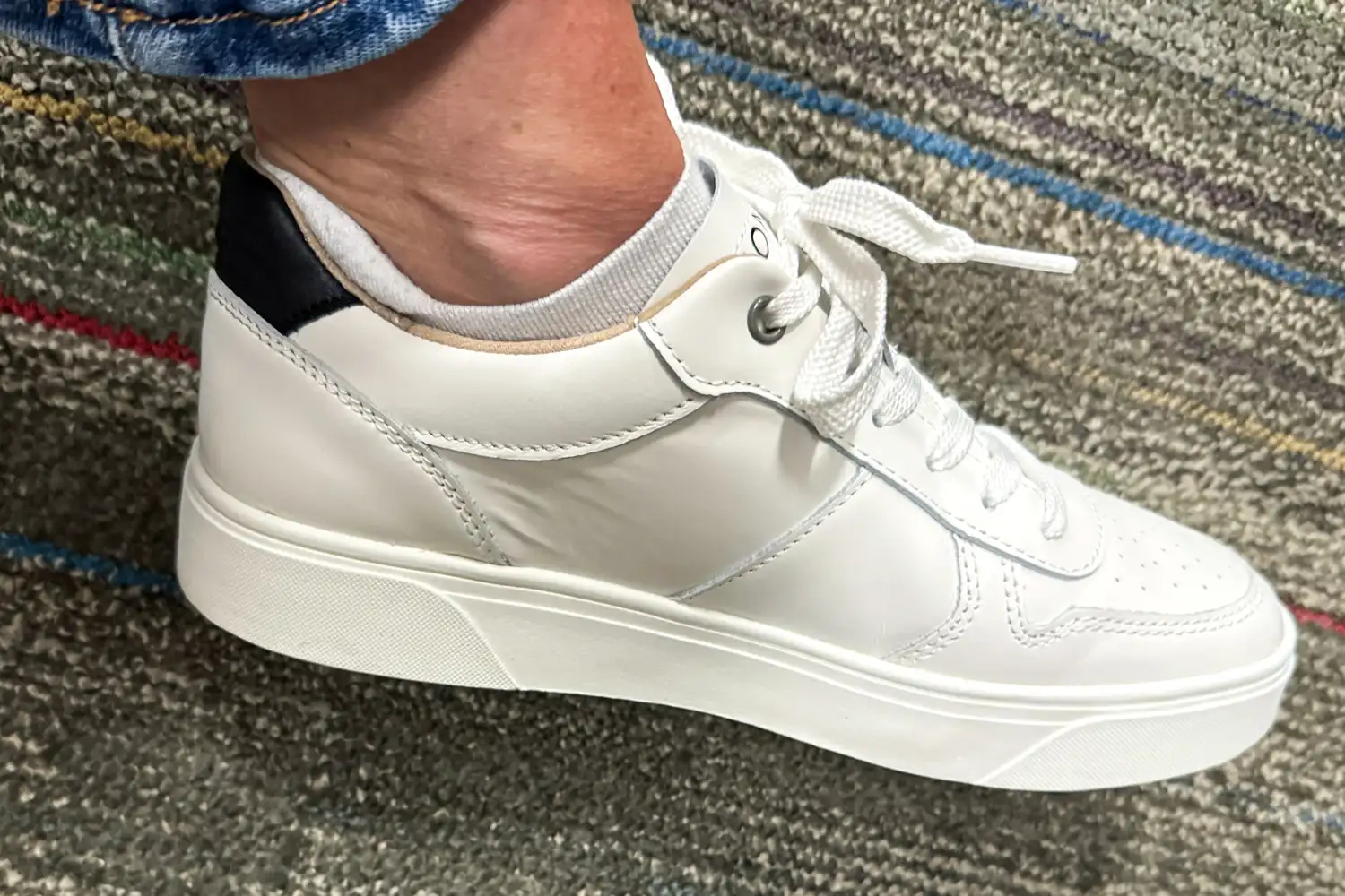 A side view of a person wearing the Vionic Women's Kimmie Court Sneakers