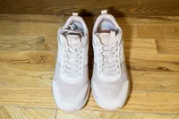 A pair of Vionic Women's Walk Strider Sneakers on a wooden floor