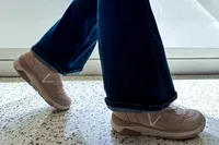 A person walking indoors wearing Vionic Women's Walk Strider Sneakers
