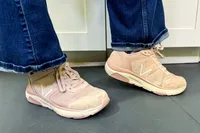 A side view of a person wearing the Vionic Women's Walk Strider Sneakers