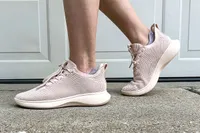 A person walks outside while wearing the Vivaia Unisex Urban Sneaker Sliders