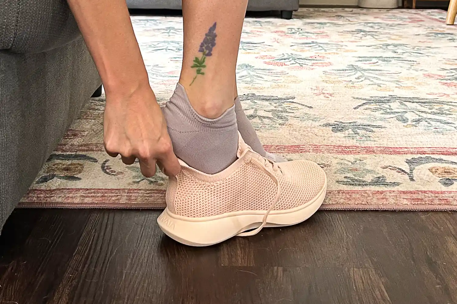 A person slides their foot into the Vivaia Unisex Urban Sneaker Sliders