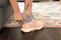 A person slides their foot into the Vivaia Unisex Urban Sneaker Sliders