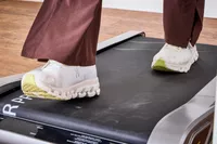 A close-up of feet walking on the Egofit Walker Pro-M1 Treadmill