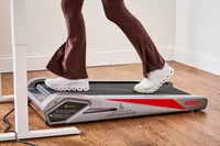 A side-view of feet walking on the Egofit Walker Pro-M1 Treadmill