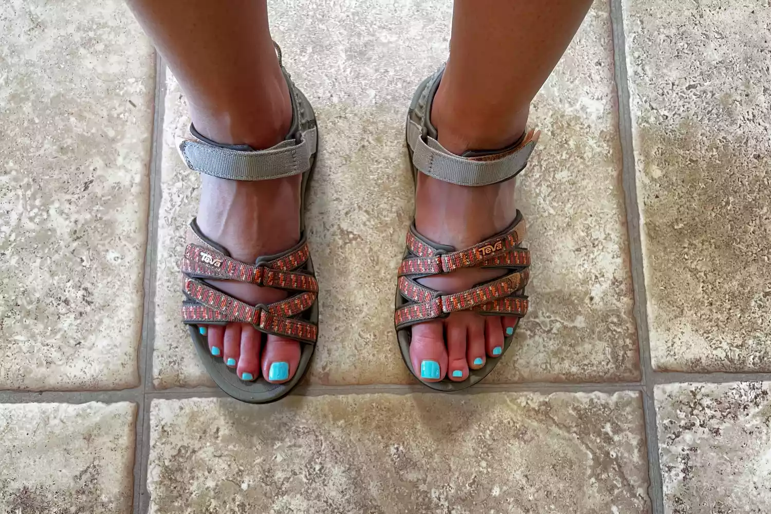 Person wearing Teva Women's Tirra Sandals on a tile floor