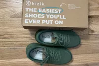 A pair of Kizik Women's Lima Shoes next to the box