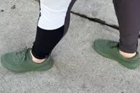 A person walks outside while wearing the Kizik Women's Lima Shoes